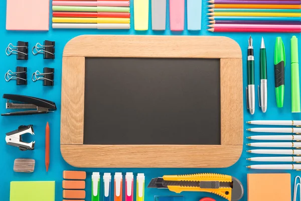 Blank chalkboard with school supplies — Stock Photo, Image