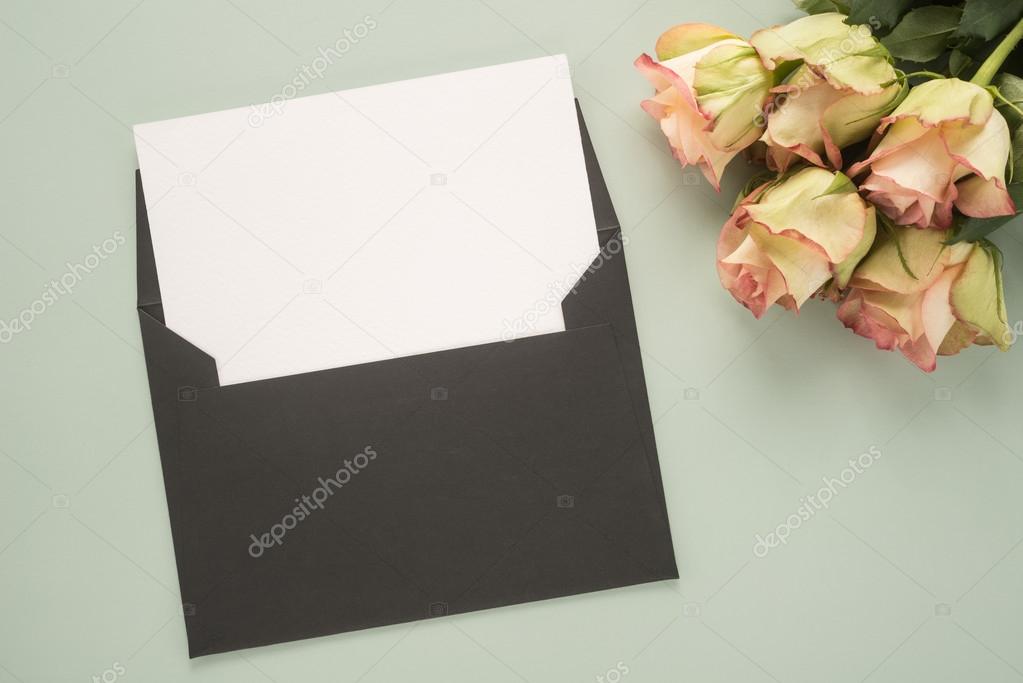 Rose flowers and blank envelope