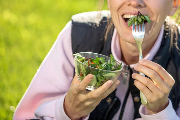 Schöne Kaukasische Frau Isst Salat Über Grünen Natürlichen Hintergrund — Stockfoto