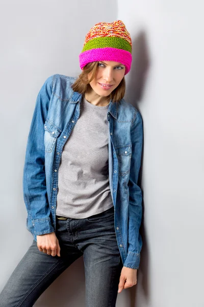 Sexy woman in knitted hat and jeans — Stock Photo, Image