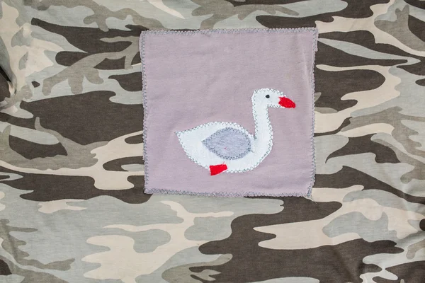 Goose on camo fabric — Stock Photo, Image