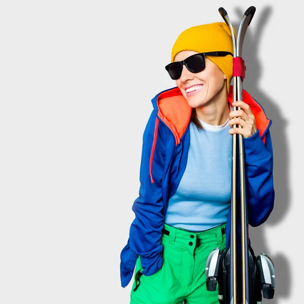 Молодая женщина с лыжами зимой — стоковое фото