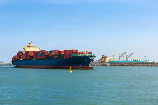 container ship loaded with containers enters the Harbor