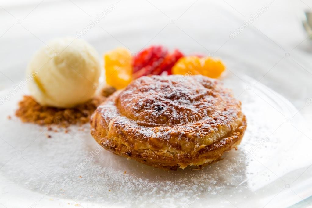 Apple pie in puff pastry served with ice cream and candied fruit