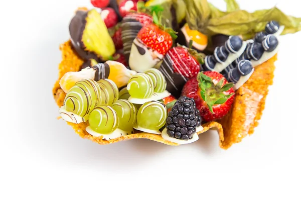 Fitness dessert: fruit salad covered with decorative chocolate