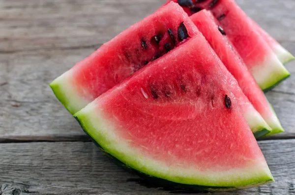 Fresh sliced watermelon on wooden background Royalty Free Stock Photos