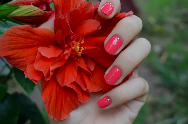 Mão de mulher com manicure rosa brilhante — Fotografia de Stock