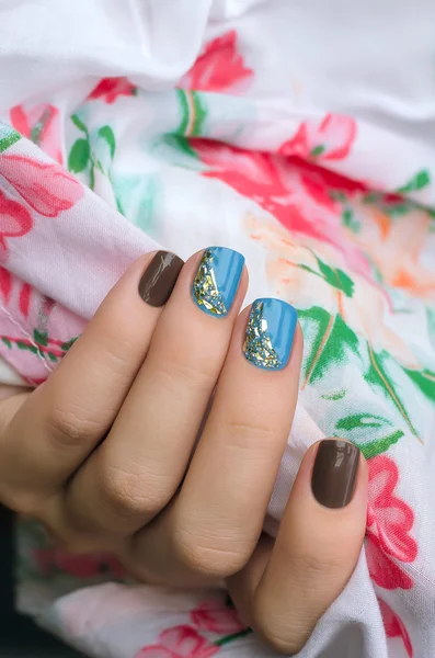 Woman hand with blue and gray nail art