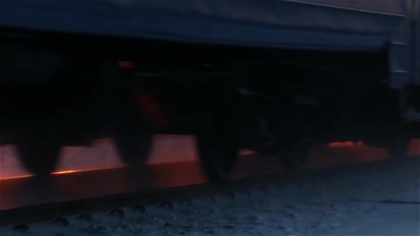 Moving train wheels close up in winter at sunset — Stock Video