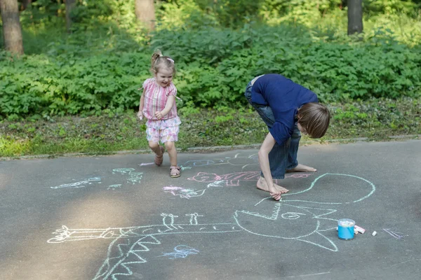 Enfants frères et sœurs qui s'amusent pendant la craie de trottoir sur la surface d'asphalte — Photo