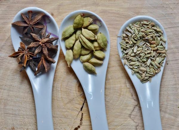 Yeşil kakule, yıldız anason ve bir kesim ağaç beyaz Seramik kaşık rezene tohum