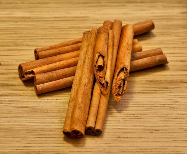 Beautifully composed of cinnamon sticks on a wooden board — Stock Photo, Image