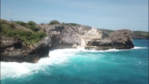 Golven breken op een rotsachtige kust luchtfoto. Gebroken strand, Nusa Penida, Indonesië — Stockvideo