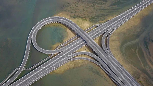 Aerial view to ring road toll way structure and construction from aerial view, nature and urban landscape of Bali before landing at the airport — Stock Photo, Image