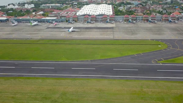 Bali, Indonezja, 4 grudnia 2020. Widok z lotu ptaka na pas startowy lotniska. Sytuacja spowodowana pandemią Covid-19. Z powodu koronawirusu, samolot pasażerski zaparkowany przy — Zdjęcie stockowe