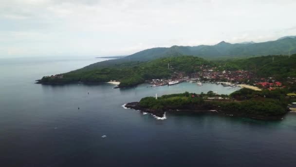 Aerial view of the stunning Padang Bai harbor and village on the eastern coast of Bali in Indonesia. Ferries to other island leave from this port and it is a famous travel destination in the island — Stock Video