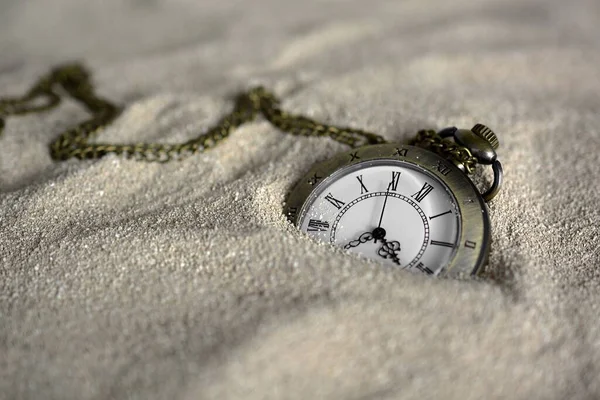 Vieille montre de poche à moitié enterrée dans le sable. Vieille montre de poche perdue dans le sable — Photo