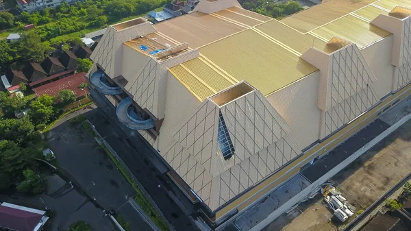 hail and storm damage roof at a new shopping mall, Kuta, Bali, Indonesia. stormy weather, Holes in exterior siding in home from damage by hail storm , climate change, danger