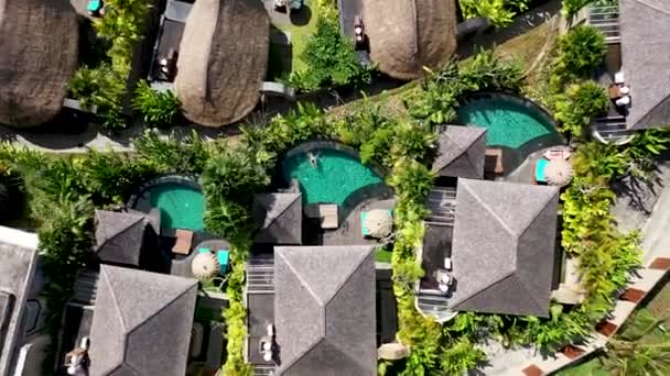Airial top down shot dari seorang pria bersantai di kolam renang properti yang indah. Kolam renang pribadi di resor hotel mewah di Ubud. Hari yang cerah di musim panas di Bali — Stok Video