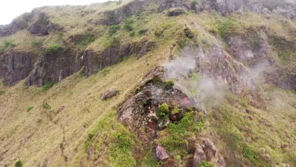 Para wynurzająca się z otworu wentylacyjnego w kraterze Mount Batur, Bali, Indonezja. Wędrówki w kalderze aktywnego wulkanu. Popularna atrakcja turystyczna. Dym i gazy uciekające z wulkanu — Wideo stockowe