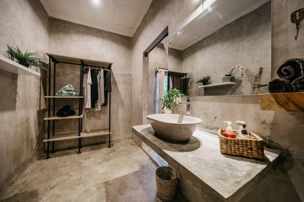 Luxury bathroom with polished concrete on the walls and PVC on the floor. Modern bathroom with cement polish walls