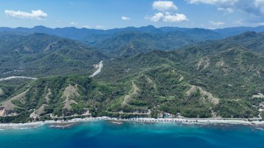 Offers a striking aerial view of hilly Flores terrain and turquoise reefs along the white-sand beaches of the island's wild north.