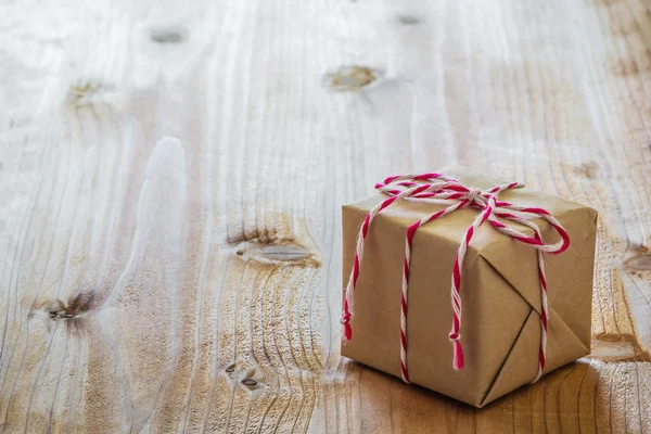 Gift box on wood board — Stock Photo, Image