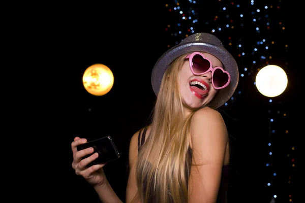 Beautiful blonde makes selfie at the disco — Stock Photo, Image