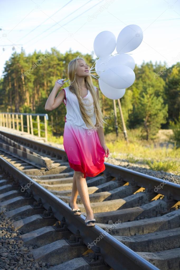 Beautiful girl with white balloons