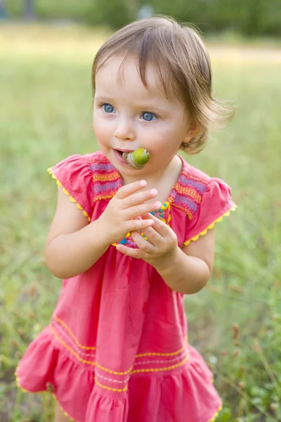 Funny little girl with acorns — Stock Photo, Image