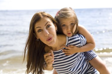 neşeli ve pozitif anne ve kızı denize yakın