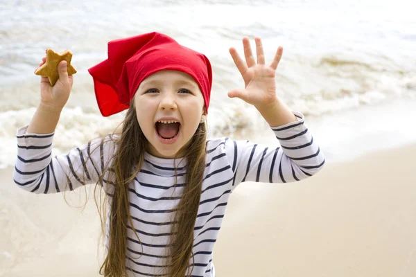 Glückliches Mädchen spielt am Strand — Stockfoto