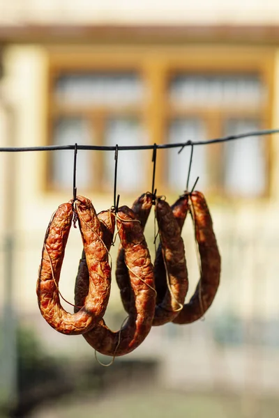 Traditional food. Smoked sausages meat hanging in domestic smokehouse. High quality photo