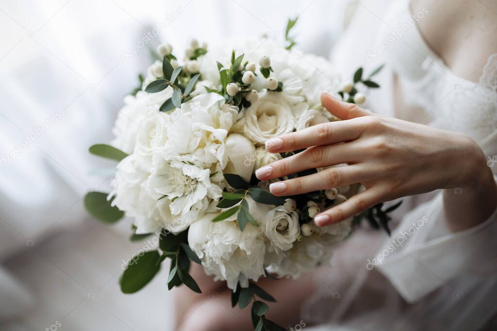 Bridal morning details. Wedding bouquet in the hands of the bride. High quality photo