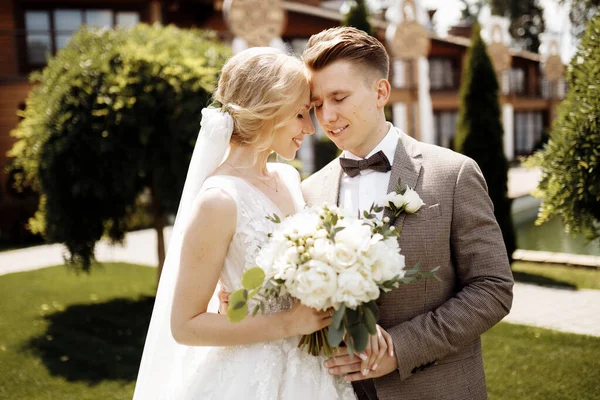 Happy beautiful wedding couple bride and groom at wedding day outdoors . Portrait of a beautiful young wedding couple