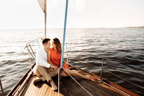 Happy couple on a yacht in the summer of celebrating honeymoon. High quality photo