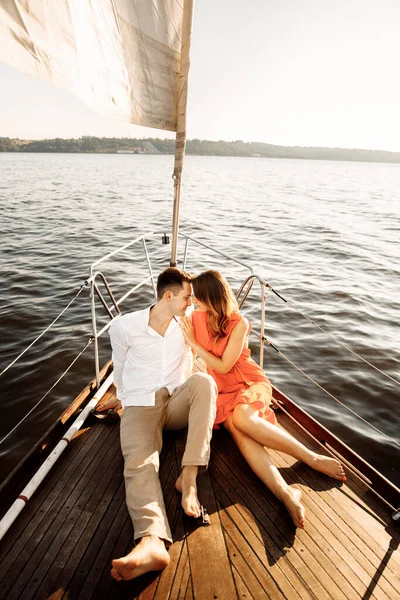 Happy couple on a yacht in the summer of celebrating honeymoon. High quality photo