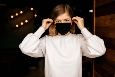 Siyah bir maske takan kız .