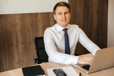 Successful businessman working at a laptop in his office, office work. High quality photo