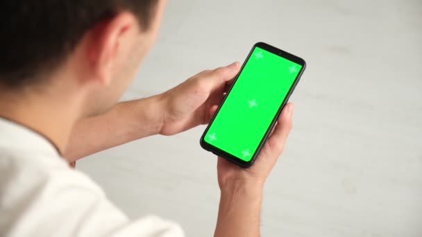 Handheld Camera: Point of View of Woman at Phone with Green Screen for Copy Space. Chromakey 20s Lady Watching Video News on Couch Close up. Tap to Click on Centre of Screen — Stock Video