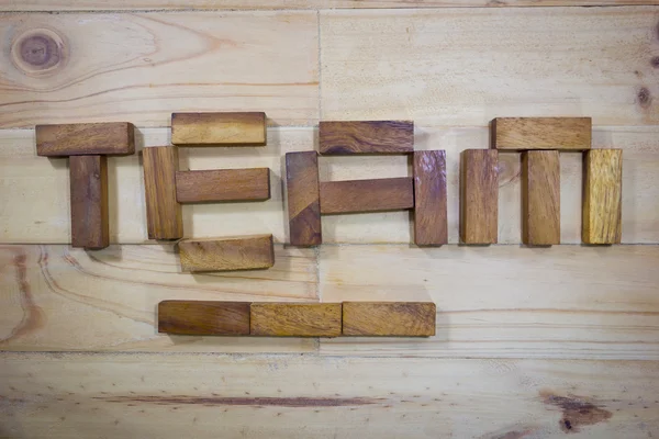 Wortteam aus Holzstäbchen auf Holzgrund — Stockfoto