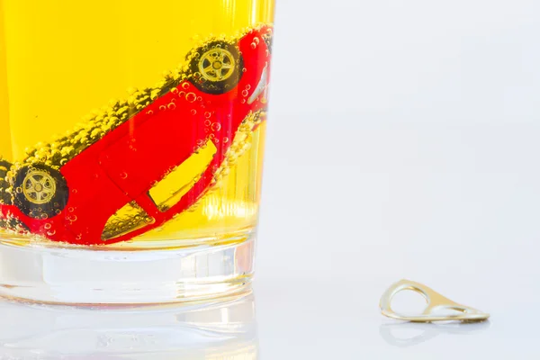 Horizontal photo of red toy car in a glass of beer isolated on white background. Drunk-driving Prevention Concept. — Stock Photo, Image