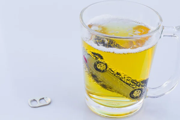 Horizontal photo of toy car in a glass of beer isolated on white background. Drunk-driving Prevention Concept. — Stock Photo, Image
