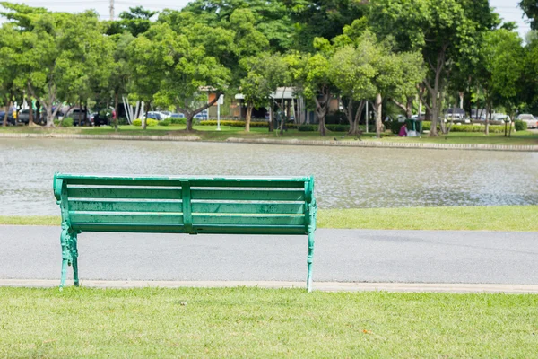 Bench in park by a pond in the background, thailand — Stock Photo, Image