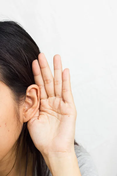 Woman holds his hand near his ear and listening — Stock Photo, Image