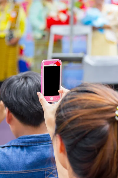 Young woman taking a photo with her phone — Stock Photo, Image