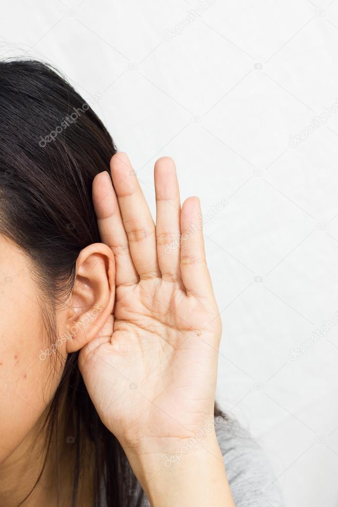 Woman holds his hand near his ear and listening