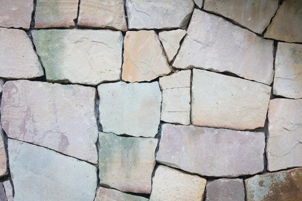 Multi-colored and multi-sized, pale rocks wall grunge texture ba