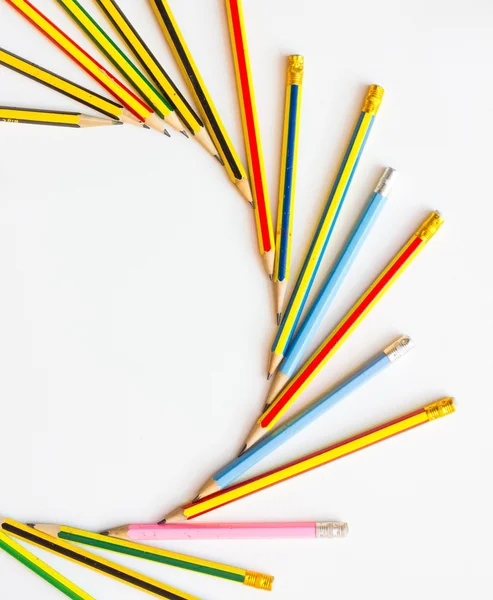 Colorful pencils on the white paper, view from above — Stock Photo, Image