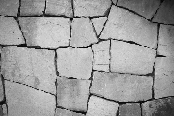Musta ja valkoinen ja monikokoinen, vaalean kiviä seinään grunge rakenne — kuvapankkivalokuva
